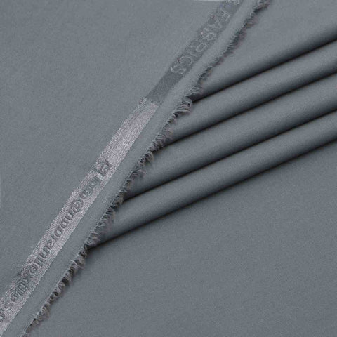 Dark gray fabric with frayed edge and visible branding on a matching background