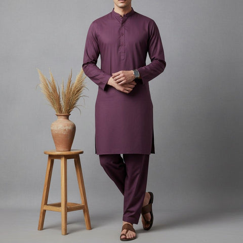 Man wearing a purple kurta with wooden stool and vase on gray background